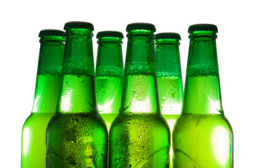 Part of the green beer bottles in drops of condensation. Isolated on a white background.