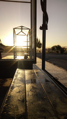 golden bus stop seat at sunrise