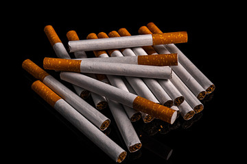 close-up macro of cigarette and filter isolated on black background