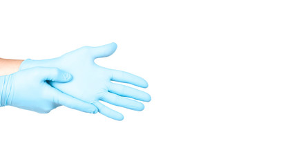 Hands of a medic in the blue latex gloves on white background. Copy space