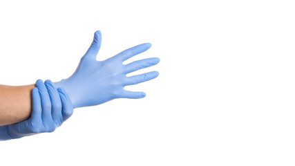 Doctor putting on protective gloves, isolated on white. Copy space
