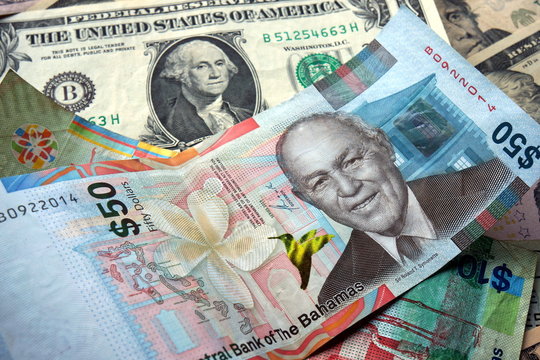 50 Bahamian dollar (BSD) bill surrounded by US dollar bank notes 