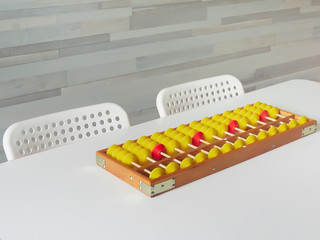 Naklejka premium Classes in mental arithmetic, abacus soroban on a white table. closeup. copy space.