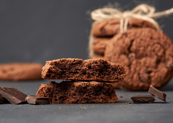 stack of baked round chocolate chip cookies and pieces of chocolate