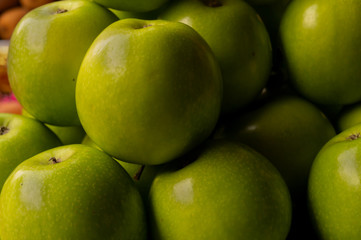 Green apple, a variety of apple created as a hybrid between the French Crab apple and the Rome beauty, displayed for sale at New Market area, Kolkata, India.