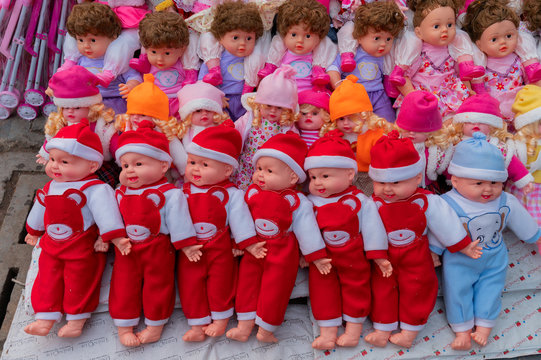Beautiful cute baby dolls for sale at retail shop at Christmas market, New Market area, Kolkata, West Bengal, India.