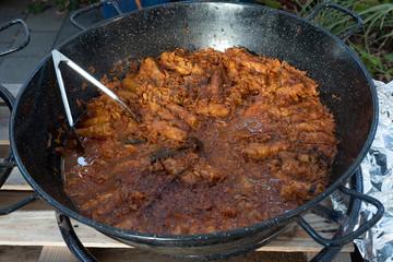 Cooking stew campfire concept, stew preparing open grill steaming.