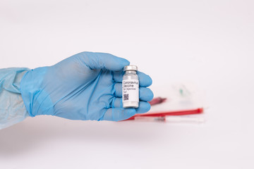 Coronavirus vaccine. Doctor with a vaccine. Hands holding a coronavirus vaccine ampoule, Covid-19