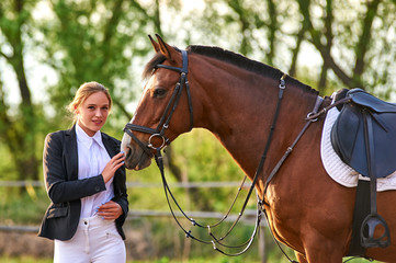 Girl horse rider stroking a horse. Horse theme