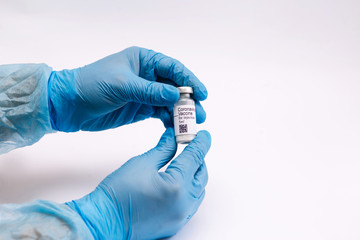 Coronavirus vaccine. Doctor with a vaccine. Hands holding a coronavirus vaccine ampoule, Covid-19