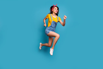 Fototapeta premium Full length body size view of her she nice attractive lovely cheerful cheery girl jumping running fast healthy life isolated on bright vivid shine vibrant blue teal turquoise color background
