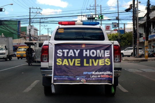 Police Car With Signage To Stay At Home Patrols The Streets During The Covid 19 Virus Outbreak