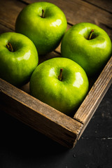 Close-up green apples on the rustic wooden background. Selective focus. Shallow depth of field.