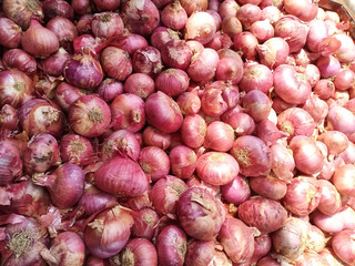 collection of heap of onions at a vegetable supermarket for sale