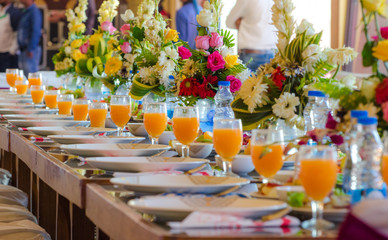 Table decorated with flowers and with Juice Glasses at Wedding
