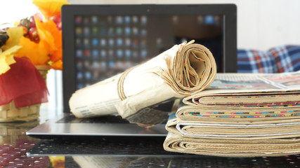 Newspapers and Laptop. Different Concepts for News - Social Network or Traditional Tabloid...