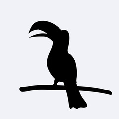 Black silhouette of a cute toucan sitting on branch. Vector © liliia_sinhina
