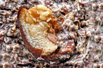 Closeup of smoked pork on mashed pinto beans 