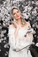 Fantasy photography - beautiful white princess with blooming tree