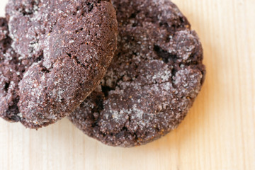 Top close up view of chocolate cookies on wooden table.Freshly baked choco biscuites.