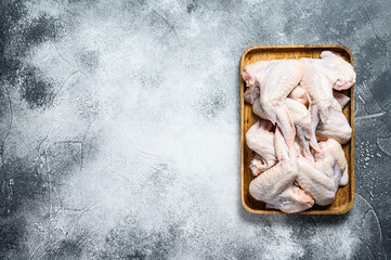 Raw chicken wings. Farm organic poultry. Top view. Gray background. Space for text