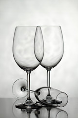 Three glasses for wine on a light background.