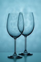 Two glasses for wine on a blue background
