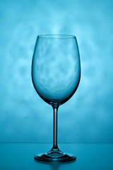 One glass on a blue background