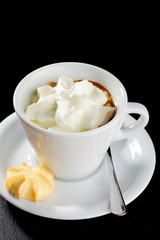 Cup of coffee with a cream on the table