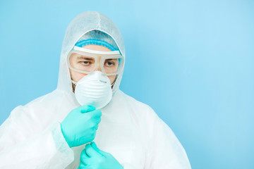 close-up portrait of tired doctor after shift in the hospital. The doctor in protective clothing - glasses, mask, gloves on white background. The doctor treating patients with coronavirus. Covid-2019