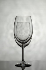 Two glasses for wine on a light background.