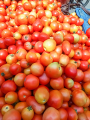 The heap of fresh red tomatoes in a vegetable supermarket for sale
