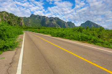 Green mountain and empty asphalt highway natural scenery ,Asphalt highways and mountains under the...