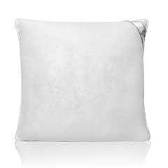 White pillow with a small relief pattern isolated on a white background with reflection