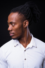 Obraz premium Face of young handsome African businessman with dreadlocks