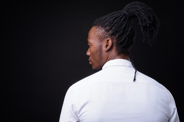 Face of young handsome African businessman with dreadlocks