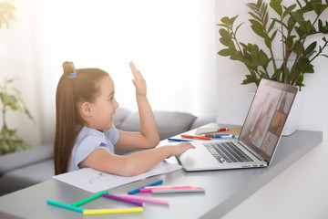 cheerfully cute girl children excited using computer learning schoolwork. kid enjoy e-learning in holiday at home.