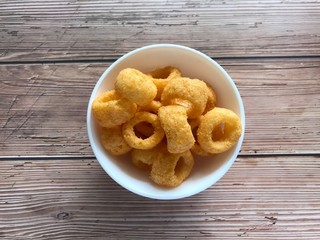 Ring cheese snacks isolated on wooden background