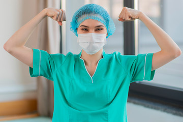 Fototapeta na wymiar Nurse showing muscles and strenght