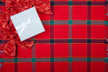 Chrismas gift boxes on the red checkered tablecloth