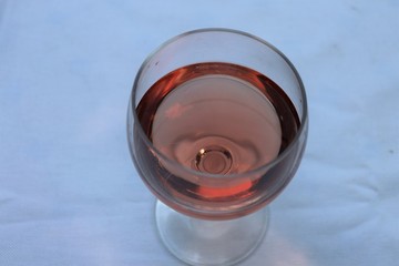 Verre de vin rosé dans un verre ballon transparent sur une nappe blanche - Département du Rhône - France