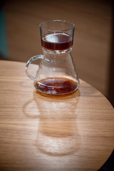 Black filter coffee on the table in cafe service kettle hario pour over cup