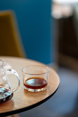 Black filter coffee on the table in cafe service kettle hario pour over cup side view