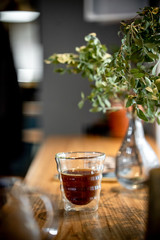 Black filter coffee on the table in cafe glass cup hario pour over cup side