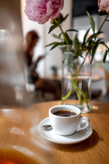 Black filter coffee on the table in cafe service kettle hario pour over cup flowers