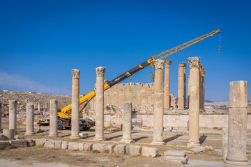 Fototapeta premium modern construction of ancient ruins,renovation of roman ruins by crane 