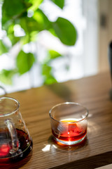 Black filter coffee on the table in cafe service kettle hario pour over cup side view