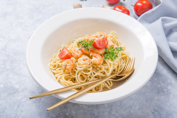 spagetti marinara with shripms.  pasta dish on grey concrete  table