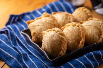Homemade chicken Curry puffs on wooden table
