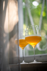 Glasses with craft beer on the window sunlight daylight  sunset morning leaf leaves